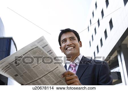 Picture - Business man holding take-out coffee cup on city street. Fotosearch