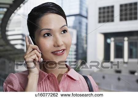Stock Image - Business man jumping mid-air above city. Fotosearch