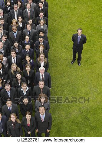 Business man standing next to large group of business people in formation, elevated view, portrait View Large Photo Image Stock Image - Business man standing next to large group of business people in formation, elevated view, portrait. Fotosearch