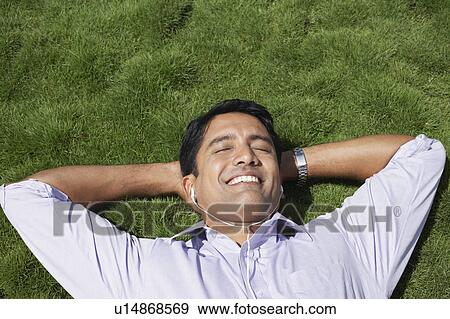 Stock Photo - Business man standing on city rooftop. Fotosearch