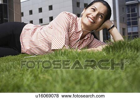 Stock Photo - Business man using mobile phone on city rooftop. Fotosearch