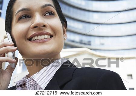 Business man using mobile phone outdoors View Large Photo Image Stock Photograph - Business man using mobile phone outdoors. Fotosearch