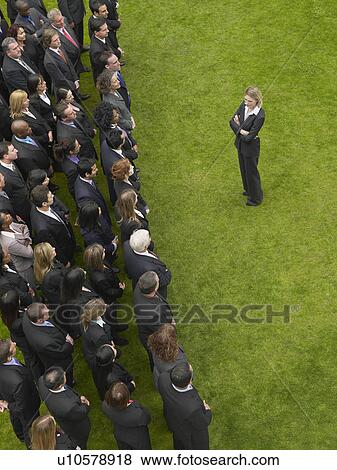 Business woman facing large group of business people in formation, elevated view View Large Photo Image Stock Photo - Business woman facing large group of business people in formation, elevated view. Fotosearch