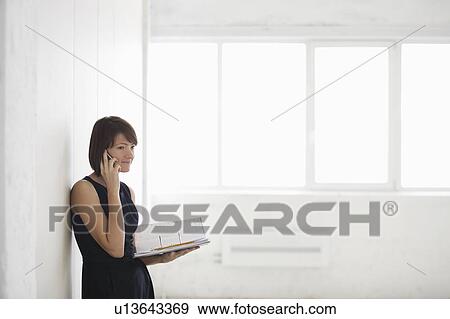 Business woman on holding file in empty warehouse View Large Photo Image Stock Photo - Business woman on holding file in empty warehouse. Fotosearch