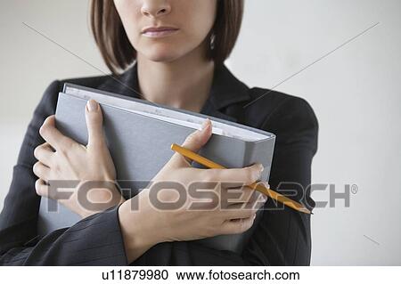 Business woman on holding file with crossed hands View Large Photo Image Stock Image - Business woman on holding file with crossed hands. Fotosearch