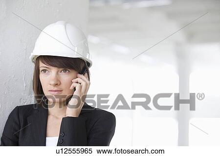 Business woman on mobile phone in empty warehouse View Large Photo Image Stock Photography - Business woman on mobile phone in empty warehouse. Fotosearch