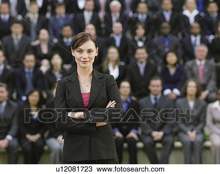 Business woman standing in front of business people sitting in bleachers, portrait View Large Photo Image Stock Image - Business woman standing in front of business people sitting in bleachers, portrait. Fotosearch