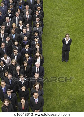 Business woman standing next to large group of business people in formation, elevated view, portrait View Large Photo Image Stock Image - Business woman standing next to large group of business people in formation, elevated view, portrait. Fotosearch