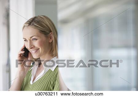 Business woman using mobile phone in office, portrait View Large Photo Image Stock Image - Business woman using mobile phone in office, portrait. Fotosearch