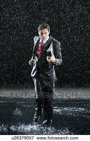 Businessman holding binder, running in Rain View Large Photo Image Stock Photo - Businessman holding binder, running in Rain. Fotosearch