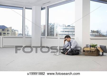 Stock Image - Businessman in Empty Office Space. Fotosearch