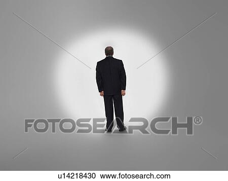 Businessman in spotlight, back view View Large Photo Image Stock Image - Businessman in spotlight, back view. Fotosearch