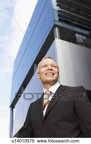 Stock Photography - Businessman, portrait, low angle view. Fotosearch