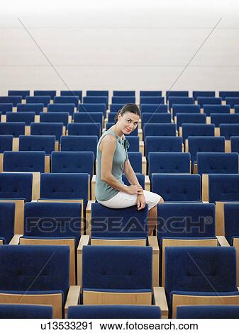 Businessman sitting alone on chair in Auditorium, portrait View Large Photo Image Stock Image - Businessman sitting alone on chair in Auditorium, portrait. Fotosearch
