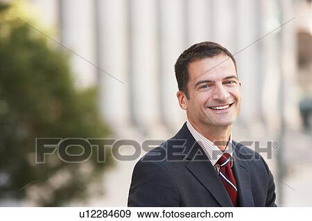 Stock Photo - Businessman smiling, outdoors, portrait. Fotosearch