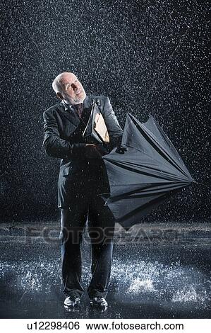 Businessman struggling to open umbrella during Sudden Rain View Large Photo Image Stock Photograph - Businessman struggling to open umbrella during Sudden Rain. Fotosearch