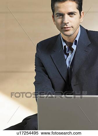 Stock Photography - Businessman Using Laptop, portrait. Fotosearch