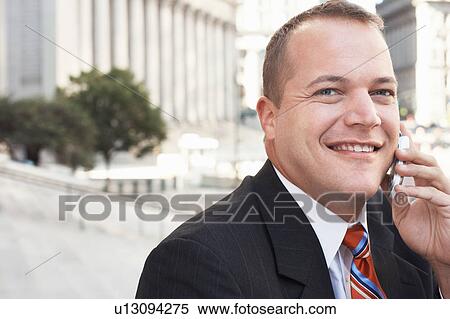 Businessman using mobile phone outdoors, portrait View Large Photo Image Stock Photography - Businessman using mobile phone outdoors, portrait. Fotosearch