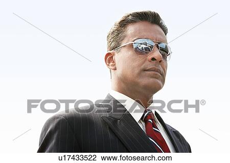Businessman wearing sunglasses, outdoors View Large Photo Image Stock Image - Businessman wearing sunglasses, outdoors. Fotosearch