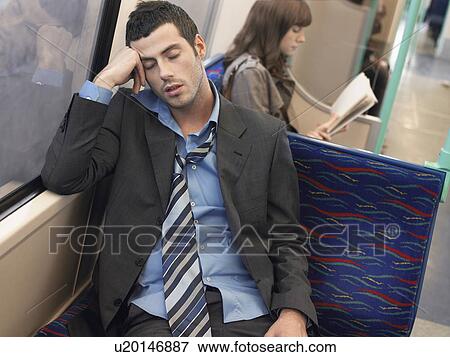 Businessman with loosened tie, sleeping on Commuter Train View Large Photo Image Stock Photo - Businessman with loosened tie, sleeping on Commuter Train. Fotosearch