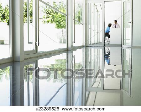 Businessmen Meeting viewed through open office door View Large Photo Image Stock Photograph - Businessmen Meeting viewed through open office door. Fotosearch
