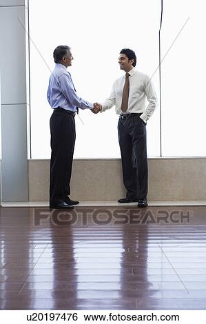 Stock Photograph - Businessmen shaking hands. Fotosearch