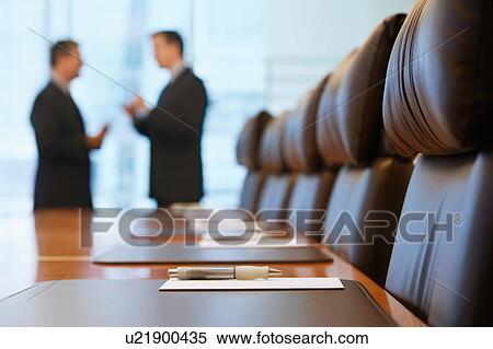 Stock Photography - Businessmen talking in conference room. Fotosearch