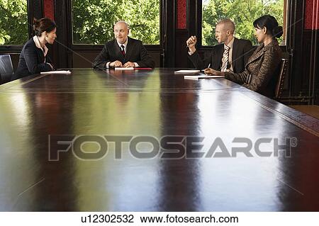 Businesspeople meeting around boardroom table View Large Photo Image Stock Image - Businesspeople meeting around boardroom table. Fotosearch
