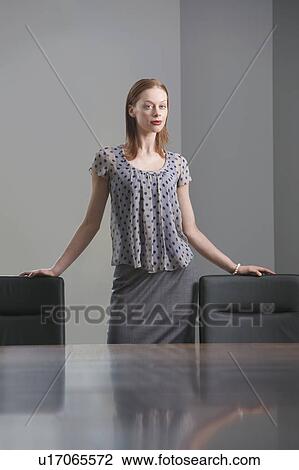 Businesswoman standing in conference room, portrait View Large Photo Image Stock Image - Businesswoman standing in conference room, portrait. Fotosearch