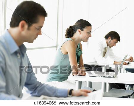 Businesswoman with laptop at desk View Large Photo Image Stock Photography - Businesswoman with laptop at desk. Fotosearch