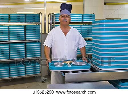 Chef stands in hospital kitchen with plastic trays View Large Photo Image Stock Image - Chef stands in hospital kitchen with plastic trays. Fotosearch
