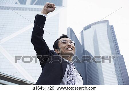 China, Hong Kong, business man with risen fist, low angle view View Large Photo Image Stock Photograph - China, Hong Kong, business man with risen fist, low angle view. Fotosearch