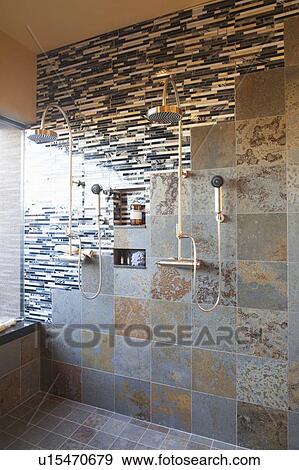 Contrasting tiles in wet room with double shower head View Large Photo Image Stock Photo - Contrasting tiles in wet room with double shower head. Fotosearch