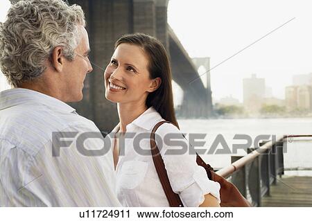 Couple embracing by bridge View Large Photo Image Stock Image - Couple embracing by bridge. Fotosearch