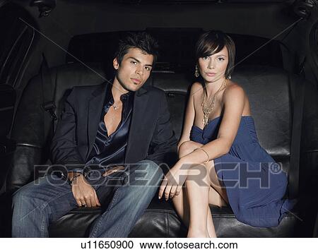 Couple in evening wear in back of limousine View Large Photo Image Stock Image - Couple in evening wear in back of limousine. Fotosearch