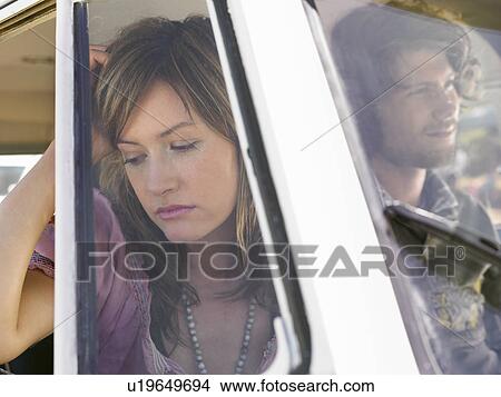 Picture - Couple in van, head and shoulders, woman looking out of window. Fotosearch