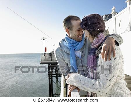 Couple laughing, standing on pier, half length View Large Photo Image Stock Photo - Couple laughing, standing on pier, half length. Fotosearch