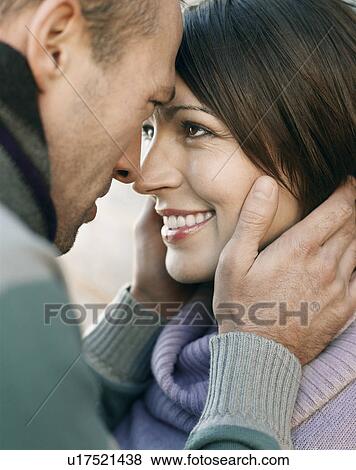Couple looking in each others eyes, outdoors, close up View Large Photo Image Stock Photo - Couple looking in each others eyes, outdoors, close up. Fotosearch