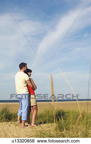 Couple on Beach Looking at Ocean View Large Photo Image Stock Photo - Couple on Beach Looking at Ocean. Fotosearch