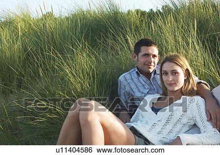 Couple Relaxing in Tall Grass, portrait View Large Photo Image Stock Photograph - Couple Relaxing in Tall Grass, portrait. Fotosearch