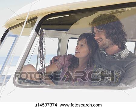 Picture - Couple Sitting in camper van, view through windscreen. Fotosearch