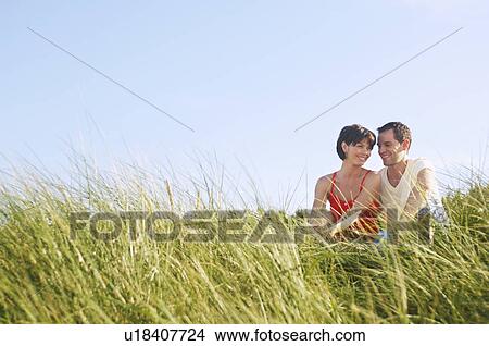 Couple Sitting in Tall Grass View Large Photo Image Picture - Couple Sitting in Tall Grass. Fotosearch