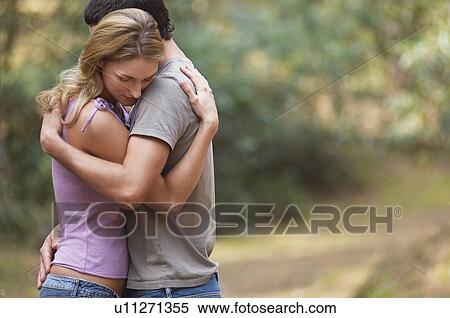 Couple standing on forest trail Hugging, side view View Large Photo Image Stock Photography - Couple standing on forest trail Hugging, side view. Fotosearch