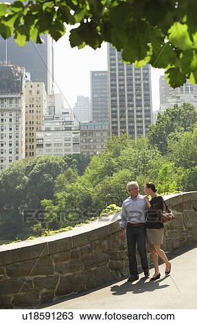 Stock Image - Couple walking in park. Fotosearch