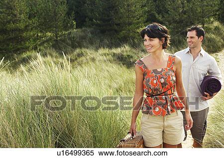 Couple walking on trail to beach View Large Photo Image Stock Photography - Couple walking on trail to beach. Fotosearch