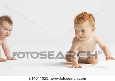 Stock Photography - Crawling baby pursuing another. Fotosearch