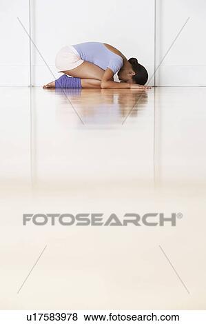 Stock Photo - Dancer, crouching in prayer position. Fotosearch