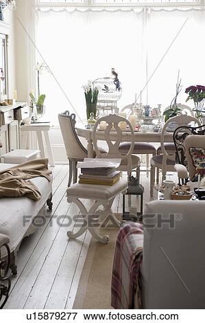 Stock Photo - Dining room with books and closed blinds, London. Fotosearch