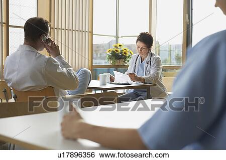 Stock Photograph - Doctors on Work Break in Cafeteria. Fotosearch