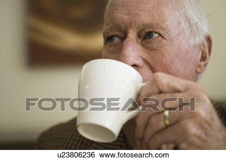 Stock Photograph - Elderly man holding cup. Fotosearch